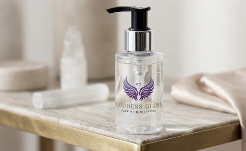 Fluidity illuminating barrier cleanser in a clear pump bottle with a silver cap and purple logo on a marble surface.
